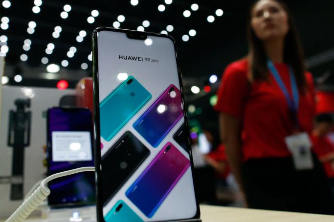 (FILE) - A Huawei smartphone is displayed next to a salesperson at the Thailand Mobile Expo 2019 in Bangkok, Thailand, 30 May 2019. Photo: Rungroj Yongrit/EPA