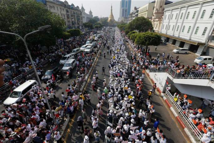Demonstrators march on the street during a protest against the Myanmar military coup, in Yangon, Myanmar, 22 February 2021. Photo: Lynn Bo Bo/EPA