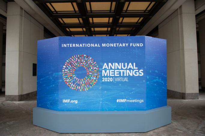 A promotional board for the virtual 2020 Annual Meetings is seen outside the International Monetary Fund at their headquarters in Washington, DC on October 13, 2020. Photo: AFP