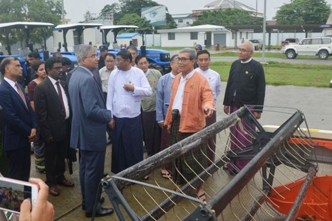 Rakhine State Chief Minister U Nyi Pu, Indian Ambassador Mr. Saurabh Kumar and guests look around agro machineries during the handover ceremony at the Sittway Port yesterday. Photo: MNA