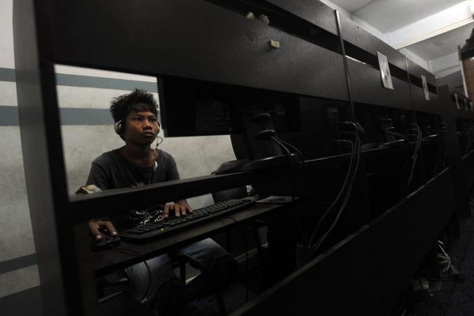 A man browsing the internet at an internet cafe in Yangon. Photo: AFP

