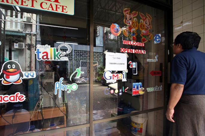A Myanmar man outside an internet cafe in Yangon. Photo: EPA
