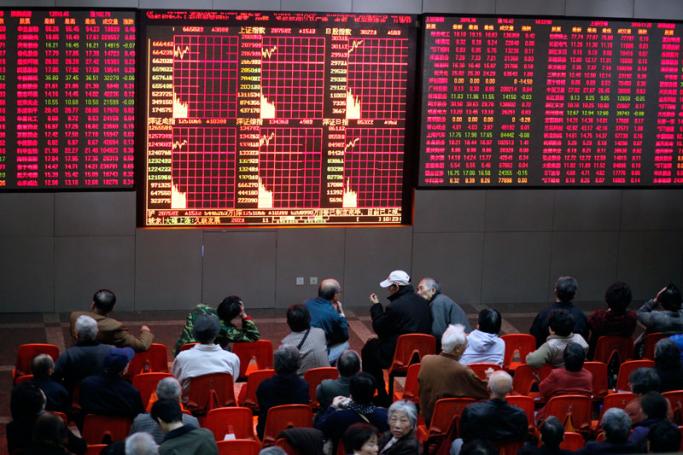 Investors monitor and trade stocks at a securities exchange house in Shanghai, China. Photo: Qilai Shen/EPA
