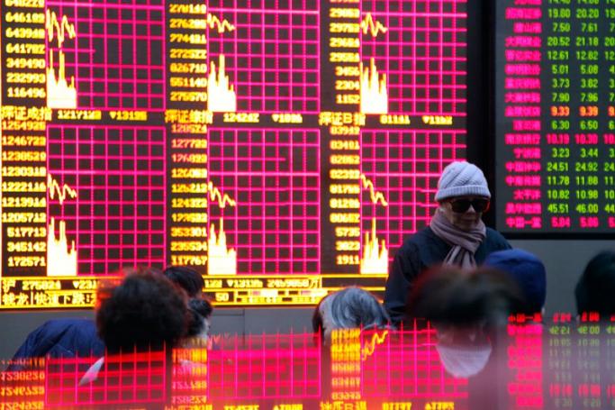 Investors monitor stock prices at a securities exchange house in Shanghai, China. Photo: Qilai Shen/EPA
