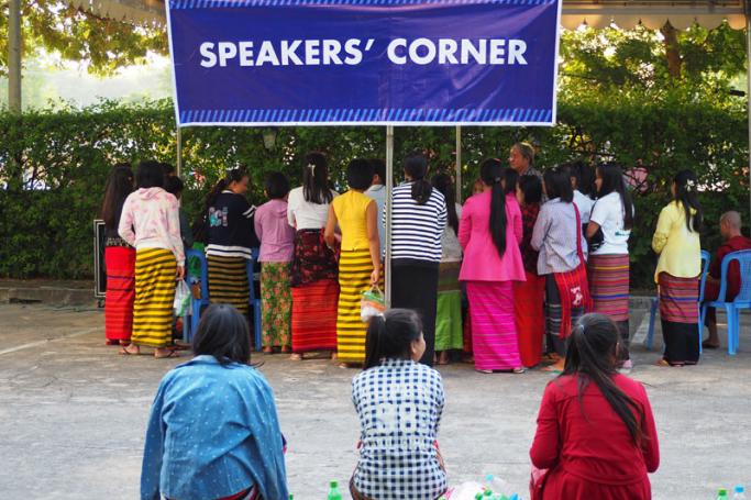 Burmese authors, monks, and passersby share their thoughts with a local audience on the grounds of the Mandalay Hill Resort. (Credit: Ben Dunant)

