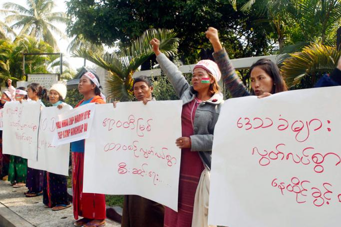 (File) Kachin people holding placards reading 'Freedom of Irrawaddy river and freedom to live for local people' shout slogans during a protest held to show opposition to the Irrawaddy Myitsone dam project, outside a hotel where the International Finance Corporation group is staying to make survey for the dam project in Myitkyina, Kachin State, Myanmar, 31 January 2017. Photo: Seng Mai/EPA