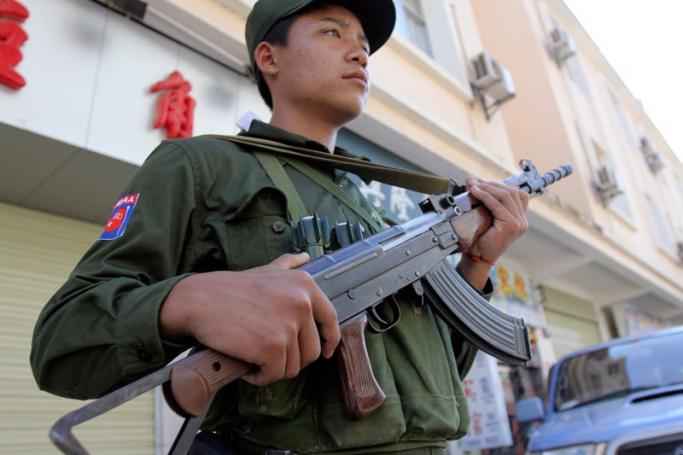 A Kokang ethnic soldier standing guard outside a hotel as journalists and diplomats attend press conference at the hotel in Myanmar-China border town Laukkai, Myanmar on September 9, 2009. Photo: Khin Maung Win/EPA
