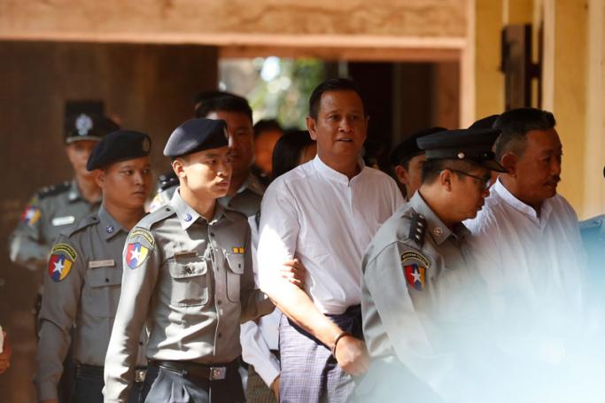 The gunman Kyi Lin (R) and Aung Win Zaw (C), an accomplice involved in planning the killing of Lawyer Ko Ni, are escorted by police as he arrives to the Yangon Northern District Court in Yangon, Myanmar, 15 February 2019. Photo: Nyein Chan Naing/EPA