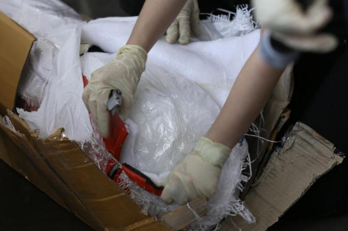 (File) Thai customs officials inspect items from seized crystal methamphetamine (Ice) drugs by hiding inside sports equipment during a press conference at the Customs X-Ray and Technology Center of the Customs Department, inside Bangkok Port (Khlong Toei) in Bangkok, Thailand, 23 December 2021. Photo: EPA