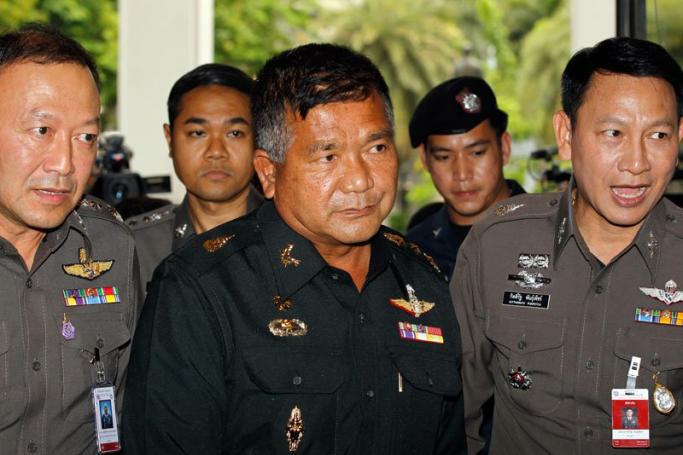 Thai Senior Army Advisor Lieutenant General Manas Kongpan (C), who is allegedly involved in human trafficking of Rohingya migrants, is escorted by police officers as he turns himself in at the Royal Thai Police headquarters in Bangkok, Thailand, 03 June 2015. Photo: Rungroj Yongrit/EPA
