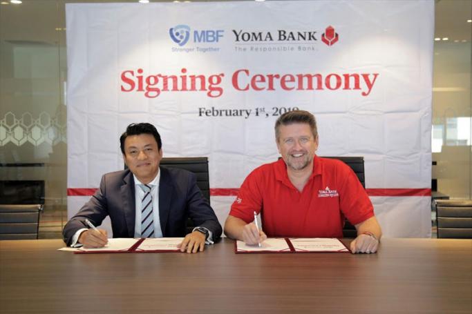U Myo San, Chief Executive Officer, Mahar Bawga Finance Company Limited and Hal Bosher, CEO of Yoma Bank sign the funding agreement at Yoma Bank Head Office on 1st February 2019.