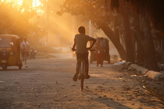 A boy rides a bicycle near the Maungdaw town market in the restive Rakhine state. Photo: Richard Sargent/AFP
