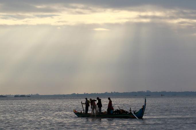 Cambodian fishermen go to work on their boat on the Mekong River in Phnom Penh, Cambodia. Photo: EPA