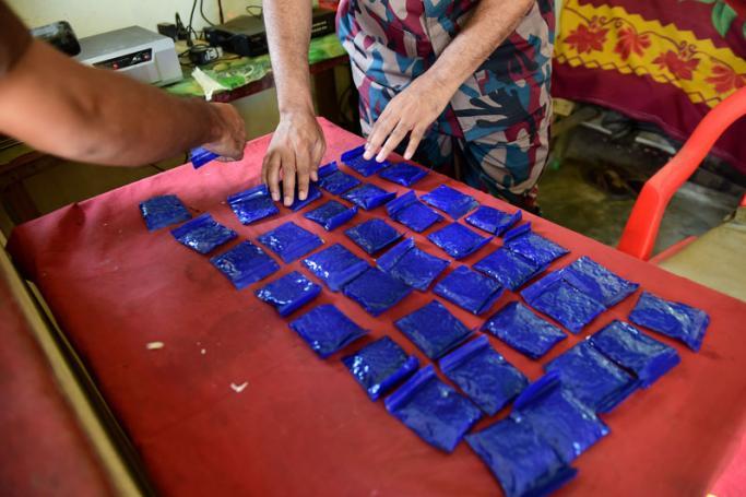 (File) A Bangladesh Border Guard (BGB) laying out small bags of the drug "yaba" recovered from a passenger bus in a search at a checkpost along the Teknaf-Cox's Bazar highway in Teknaf. Photo: Munir Uz Zaman/AFP 