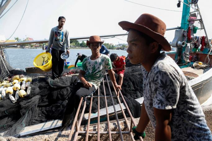 Migrant fishermen from Myanmar rest on a Thai fishing boat upon their arrival at a port in Samut Sakhon province, Thailand. Photo: Rungroj Yongrit/EPA
