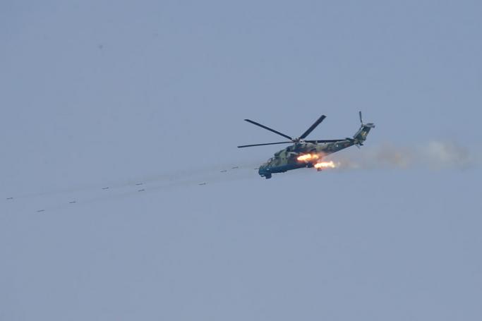 (File) A military helicopter from the Myanmar Air Force fires at targets during 'Sin Phyu Shin' joint military exercises in Ayeyarwaddy delta region, Myanmar, 02 February 2018. Photo: EPA