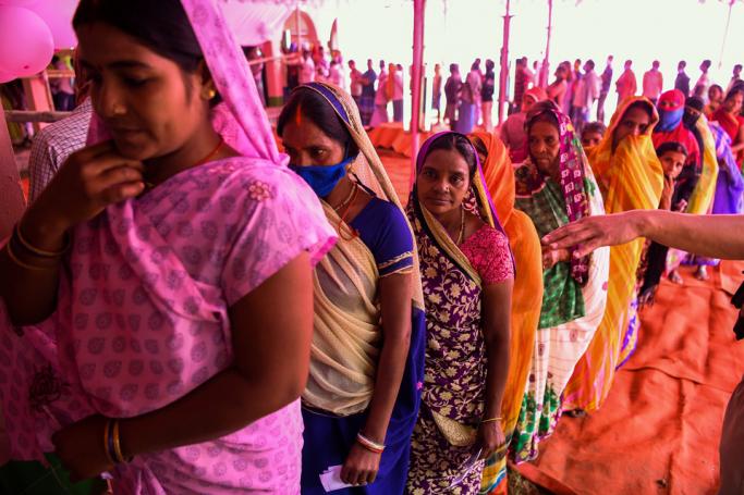 Voters queue up to cast their ballots for Bihar state assembly elections at a polling station in Masaurhi on October 28, 2020. Photo: AFP