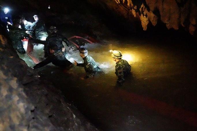 A handout photo made available by the Royal Thai Navy on shows a Thai 'Navy Seal' Underwater Demolition Assault Unit team wading through the flood as they inspect inside the cave during a search and rescue operation for a missing football team at the Tham Luang cave in Tham Luang Khun Nam Nang Noon Forest Park in Chiang Rai province, Thailand, 30 June 2018. Photo: EPA/ Royal Thai Navy
