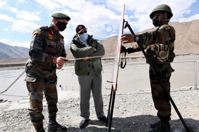 A handout photo made available by the Indian Press Information Bureau (PIB) shows the Prime Minister of India Narendra Modi (C) looks at a map in Leh, Ladakh, India, 03 July 2020. Photo: EPA