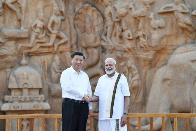 A handout photo made available by the Indian Press Information Bureau (PIB) shows Indian Prime Minister Narendra Modi (R) and Chinese President Xi Jinping at the at Arjuna’s Penance monument during the 2nd informal summit at Mamallapuram, India 11 October 2019. Photo: EPA