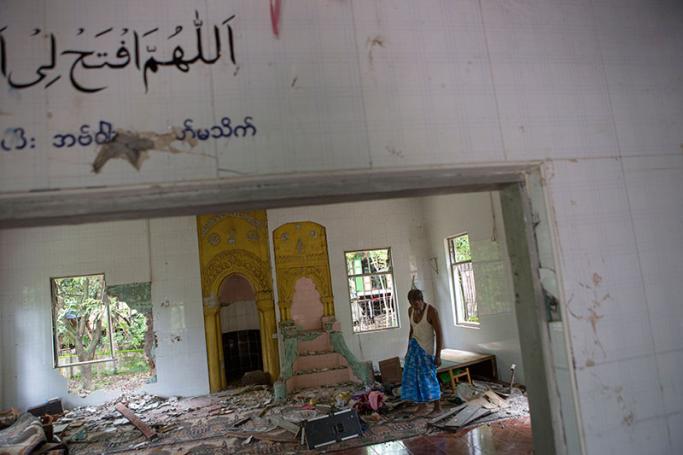 Ibrahim, 67, looks around inside the destroyed mosque at Thuye Tha Mein village of Waw township in Bago Province, Myanmar, 24 June 2016. Photo: Lynn Bo Bo/EPA
