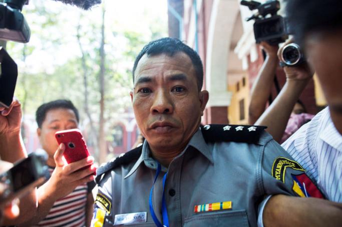Myanmar deputy police major Moe Yan Naing (C) leaves the court following the ongoing trial of two detained journalists in Yangon on April 20, 2018. Photo: Sai Aung Main/AFP
