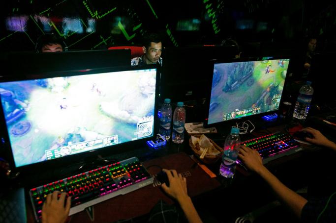 This photo taken on August 22, 2019 shows eSports professional player Myint Myat Zaw (back R), also known as "Insane", playing Dota 2 at an eSports shop in Yangon. Photo: Sai Aung Main/AFP