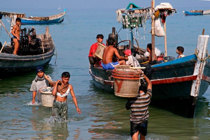 Southeast Asia's fishing industry is in trouble, with problems of overfishing and allegations of slavery. Fishermen unload their catch from small fishing boats at Jatetaw fishing village, Ngapali beach, Myanmar. Photo: Gernot Hensel/EPA
