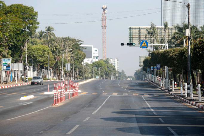 A car drives pass on the empty road in Yangon, Myanmar, 01 February 2022. Photo: EPA