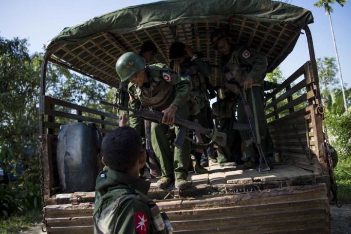(File) Myanmar soldiers arrive as they bring the residents displaced from the conflict between a group of armed Muslim militants and government troops, to take refuge at a Buddhist monastery in Maungdaw located in Rakhine State near the Bangladesh border on October 15, 2016. Photo: Ye Aung Thu/AFP