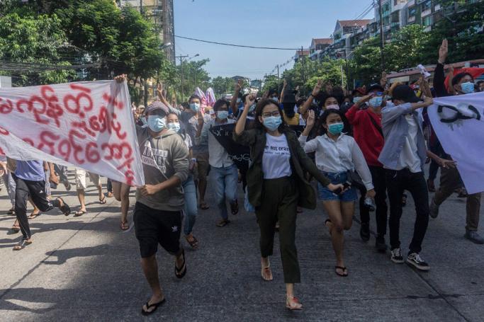 Protesters hold up banners and the three-finger salute during a demonstration against the military coup in Yangon on May 14, 2021. Photo: AFP