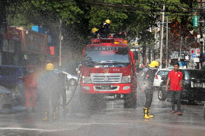  Firefighters spray disinfectant on the street to curb the spread of coronavirus in Yangon, Myanmar, 24 April 2020. Photo: Nyein Chan Naing/EPA