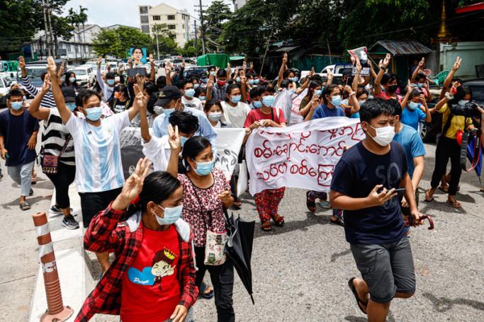 Protesters make the three-finger salute as they take part in a demonstration against the military coup and mark the birthday of Myanmar's detained civilian leader Aung San Suu Kyi in Yangon on June 19, 2021.  Photo: AFP