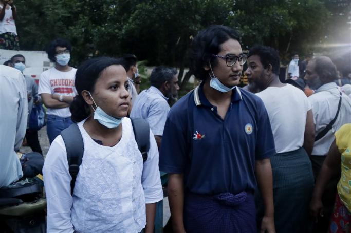 (File) Myanmar journalist K Zune Nway (L) and photojournalist Ye Myo Khant (R) talk to media colleagues outside the Insein prison after they were released from detention, Yangon, Myanmar, 30 June 2021. Photo: EPA