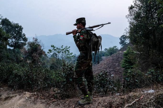 In this photo taken on 9 March, 2023 a member of ethnic rebel group Ta’ang National Liberation Army (TNLA) patrols near Namhsan Township in Myanmar’s northern Shan State. Photo: AFP