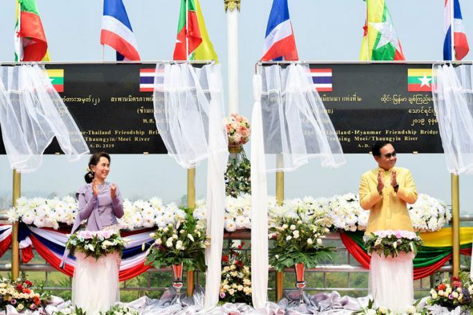 (File) Thai Prime Minister Prayut Chan-o-cha (R) and Myanmar's state counselor Aung San Suu Kyi (L) clapping during an event to mark the completion of the second Thailand-Myanmar Friendship Bridge in the Thai-Myanmar border city of Mae Sot, Tak province, Thailand, 19 March 2019. Photo: Royal Thai Government