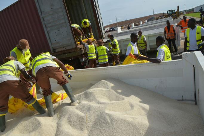 Workers unload non-compliant rice of Burmese origin from a truck at The Kossihouen Waste Disposal and Technical Landfill Centre some 45kms from Abidjan on April 16, 2019, ahead of it's destruction. Photo: Sia Kambou/AFP