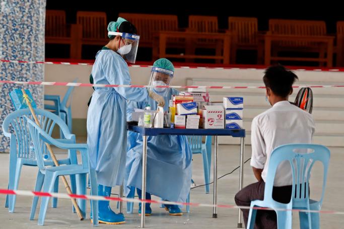 Doctors prepare medicine for a patient inside the Community Fever Clinic which opens, temporarily, at Hlaing Thar Yar town hall in Yangon, Myanmar, 29 April 2020. Photo: Nyein Chan Naing/EPA