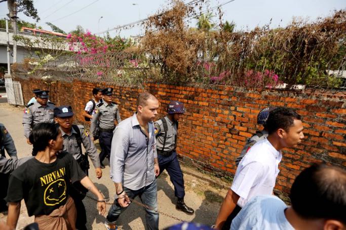 Philip Blackwood (C), with U Tun Thurein and U Htut Ko Ko Lwin being taken to court on March 17, 2015. They were sentenced to two and a half years in jail over the posting of an image of Buddha wearing headphones on Facebook. Photo: Thet Ko/Mizzima
