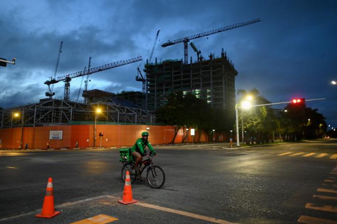 A food delivery worker rides a bike on an empty Yangon street on September 29, 2020 as Myanmar's biggest city goes into a strict lockdown following a surge of Covid-19 coronavirus cases. Photo: Ye Aung Thu/AFP