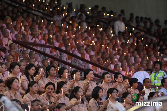 People hold candles during the Interreligious Gathering of Prayer for Peace ceremony at Yangon football stadium on 10 October 2017. Photo: Thura/Mizzima
