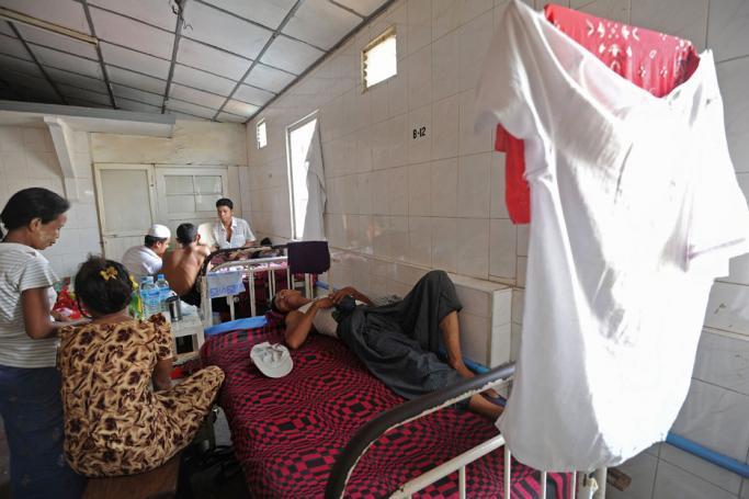A patient lying on a bed at a charity-run clinic in Yangon. Photo: AFP