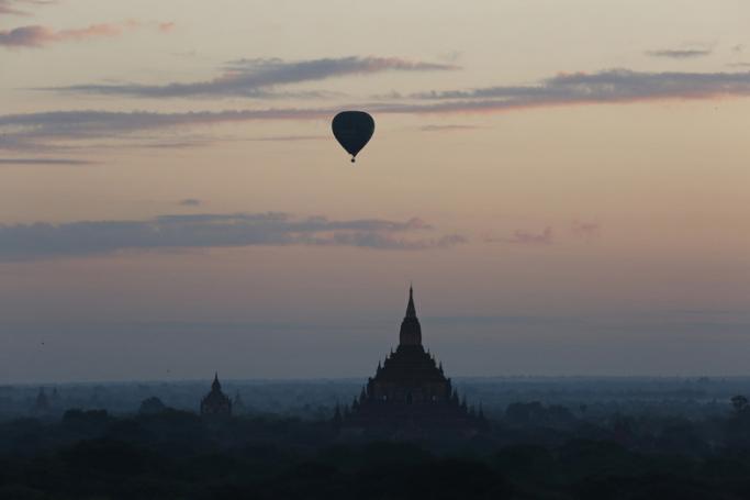 Balloons carrying visitors sit in the sky during sunrise in Bagan, Myanmar. Photo: EPA