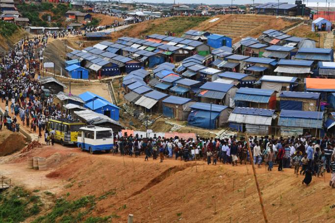 Rohingya refugees walk to attend a ceremony organised to remember the first anniversary of a military crackdown that prompted a massive exodus of people from Myanmar to Bangladesh, at the Kutupalong refugee camp in Ukhia on August 25, 2018. Photo: Dibyangshu Sarkar/AFP