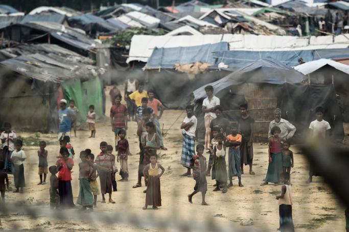 Rohingya refugees gather near their shelters in the "no man's land" behind Myanmar's boder lined with barb wire fences in Maungdaw district, Rakhine state bounded by Bangladesh on April 25, 2018. Photo: Ye Aung Thu/AFP
