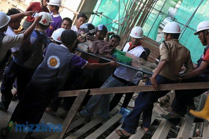 Rescue workers rescue a construction worker after the scaffolding collapse at the Pullman Hotel construction project in Mandalay on 20 June 2015. Photo: Bo Bo/Mizzima
