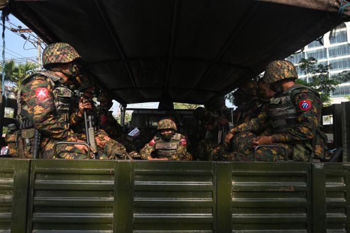  Subject: Soldiers sit in an army truck outside the Central Bank of Myanmar, as people gathered to protest against the military coup, in Yangon on February 15, 2021.  Photo: AFP