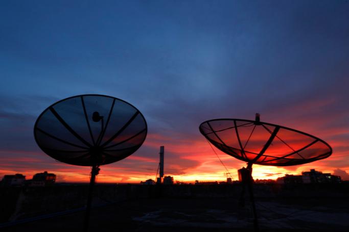 A view of satellite TV dishes, mounted on a building, at sunset in Yangon, Myanmar. Photo: Lynn Bo Bo/EPA