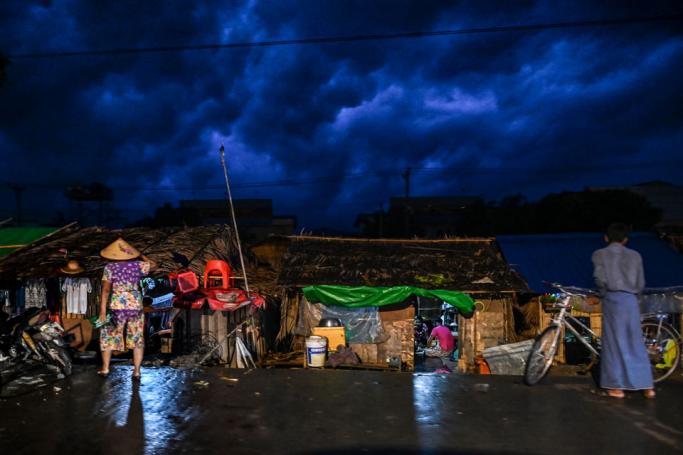 Rain clouds over a slum area are seen on the outskirts of Yangon. Photo: Ye Aung Thu/AFP