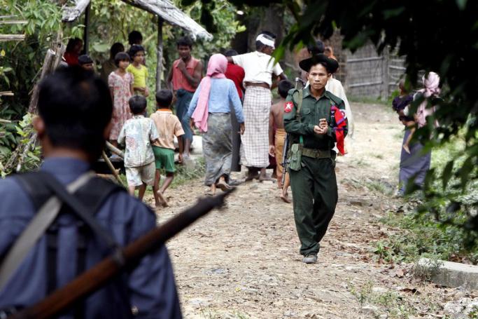 (File) Myanmar soldier and policeman walk at the Pike The village, Minbya township, western Myanmar. Photo: EPA